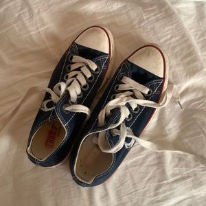Blue and white converse type of sneakers with a red boarder
